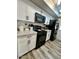 Modern kitchen with white cabinets, black appliances, and granite countertops at 14821 N 51St Dr, Glendale, AZ 85306
