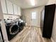 Bright laundry room with washer, dryer, and ample storage at 14821 N 51St Dr, Glendale, AZ 85306