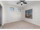 Bright bedroom with neutral carpeting and ceiling fan at 15139 W Pierson St, Goodyear, AZ 85395