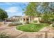 Spacious backyard oasis with a sparkling pool, lush lawn, and a covered patio at 15791 W Westview Dr, Goodyear, AZ 85395