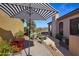 Relaxing patio space with a striped umbrella and red bistro table and chairs at 15816 E Brittlebush Ln, Fountain Hills, AZ 85268