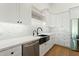 Contemporary kitchen features white cabinets, marble countertops, and herringbone backsplash at 1718 W Maddock Rd, Phoenix, AZ 85086