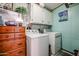 Laundry room with washer, dryer, and wooden cabinets at 17200 W Bell Rd # 1737, Surprise, AZ 85374