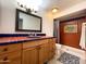 Bathroom with tile shower, wood vanity, and decorative tile accents at 18802 N 44Th Pl, Phoenix, AZ 85050