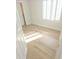 Sunlit bedroom with wood-look flooring, white walls, and plantation shutters at 18802 N 44Th Pl, Phoenix, AZ 85050
