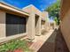 Side view of the home showcasing a walkway and landscaping at 18802 N 44Th Pl, Phoenix, AZ 85050