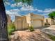 Tan stucco home with brick walkway and attached garage at 18802 N 44Th Pl, Phoenix, AZ 85050