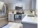 Modern kitchen with stainless steel appliances and white cabinets at 18802 N 44Th Pl, Phoenix, AZ 85050