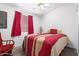 Bedroom with double bed, red accents and rocking chair at 2229 N Higley Rd, Mesa, AZ 85215