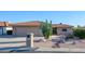 Single-story home with desert landscaping and a two-car garage at 25660 S Howard Dr, Sun Lakes, AZ 85248