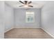 Well-lit bedroom featuring a ceiling fan and large window at 25905 N 122Nd Ln, Peoria, AZ 85383