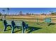 Golf course with benches and a sign reminding golfers to stay within the boundaries at 26409 S Howard Dr, Sun Lakes, AZ 85248