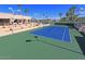 Community tennis court with surrounding benches and views of the golf course at 26409 S Howard Dr, Sun Lakes, AZ 85248