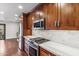 Modern kitchen features wood cabinets and gas range at 5414 N 78Th Pl, Scottsdale, AZ 85250