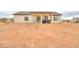 Home's backyard with covered patio, ample space, and desert landscaping at 6293 N Telly Ln, Casa Grande, AZ 85194