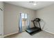 Bright bedroom with a treadmill and large window offering a view at 6293 N Telly Ln, Casa Grande, AZ 85194