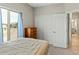 Bedroom with double doors leading to the bathroom and views of the backyard at 6293 N Telly Ln, Casa Grande, AZ 85194