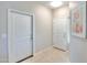 Bright entryway with neutral walls and tile flooring, featuring two white doors at 6293 N Telly Ln, Casa Grande, AZ 85194