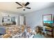 Bright bedroom with a queen bed, built-in desk, and ceiling fan at 6805 E 2Nd St # 4, Scottsdale, AZ 85251