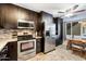 Kitchen features stainless steel appliances and dark cabinetry at 6805 E 2Nd St # 4, Scottsdale, AZ 85251
