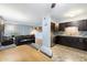Modern kitchen with dark cabinetry, stainless steel appliances, and tiled floors at 6805 E 2Nd St # 4, Scottsdale, AZ 85251