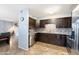 Modern kitchen with dark cabinetry, stainless steel appliances, and tile flooring at 6805 E 2Nd St # 4, Scottsdale, AZ 85251