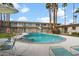 Community pool with surrounding patio furniture and landscaping at 6805 E 2Nd St # 4, Scottsdale, AZ 85251