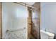 Shower with patterned glass door and tile surround at 6805 E 2Nd St # 4, Scottsdale, AZ 85251