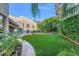 Expansive backyard with artificial turf and lush greenery at 8437 N 84Th Pl, Scottsdale, AZ 85258