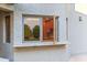 Exterior view showcasing a kitchen window and granite countertop at 8437 N 84Th Pl, Scottsdale, AZ 85258