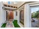 Ornate wood door entry with a stone pathway and landscaping at 8437 N 84Th Pl, Scottsdale, AZ 85258