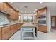 Spacious kitchen featuring wood cabinets, granite countertops, and an island at 8437 N 84Th Pl, Scottsdale, AZ 85258