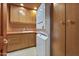 Laundry room with wood cabinets and stackable washer/dryer at 8437 N 84Th Pl, Scottsdale, AZ 85258