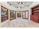 Sunlit sitting room with built-in shelving and wood floors at 8437 N 84Th Pl, Scottsdale, AZ 85258
