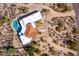 Overhead view of a home with a pool and terracotta roof in a desert setting at 9446 E Romping Rd, Carefree, AZ 85377