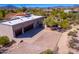 Aerial view of house, pool, and landscaped yard with mountains in background at 9446 E Romping Rd, Carefree, AZ 85377