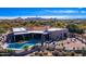 Aerial view of home with pool and desert landscaping; mountain views at 9446 E Romping Rd, Carefree, AZ 85377