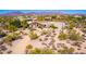 Aerial view of a home with desert landscaping and mountain views in the background at 9446 E Romping Rd, Carefree, AZ 85377