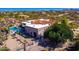 Aerial view of a single-story home with a pool and desert landscape at 9446 E Romping Rd, Carefree, AZ 85377