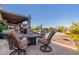 Inviting backyard with a sparkling pool, patio furniture, and a covered patio at 9446 E Romping Rd, Carefree, AZ 85377