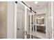 Modern bathroom with mirrored closet doors and a light wood vanity at 9446 E Romping Rd, Carefree, AZ 85377