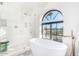 Bathroom with walk-in shower, freestanding tub and patterned floor at 9446 E Romping Rd, Carefree, AZ 85377