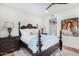 Spacious bedroom with a large bed, artwork, and an ensuite bathroom at 9446 E Romping Rd, Carefree, AZ 85377