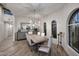 Bright dining room with a rustic wooden table and statement chandelier at 9446 E Romping Rd, Carefree, AZ 85377
