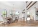 Elegant dining room with a rustic wood table, chandelier, and hardwood floors at 9446 E Romping Rd, Carefree, AZ 85377