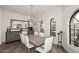 Spacious dining room with hardwood floors, large windows, and a rustic table at 9446 E Romping Rd, Carefree, AZ 85377