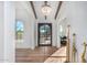 Light-filled entryway featuring arched windows and a modern black door at 9446 E Romping Rd, Carefree, AZ 85377