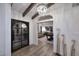 Bright entryway with arched doorway, wood floors, and statement chandelier at 9446 E Romping Rd, Carefree, AZ 85377