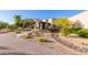 Landscaped front yard with desert plants and brick driveway at 9446 E Romping Rd, Carefree, AZ 85377