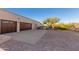 Three-car garage with brick paver driveway at 9446 E Romping Rd, Carefree, AZ 85377